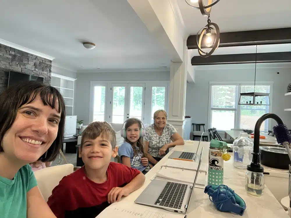 me sitting at the kitchen island with my kids homeschooling and working on laptops
