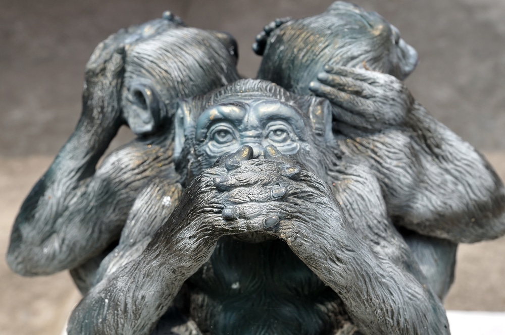 statue of three monkeys covering eyes, ears and mouth