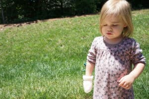Indie wearing a mitten in June