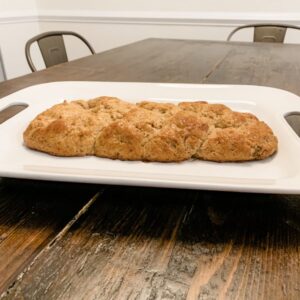 braided loaf of gluten free challah bread on a white serving platter