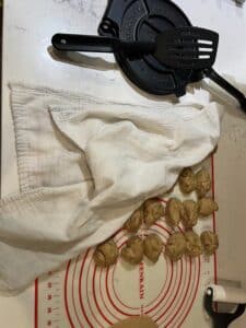 balls of tortilla dough partially covered with a clean white tea towel