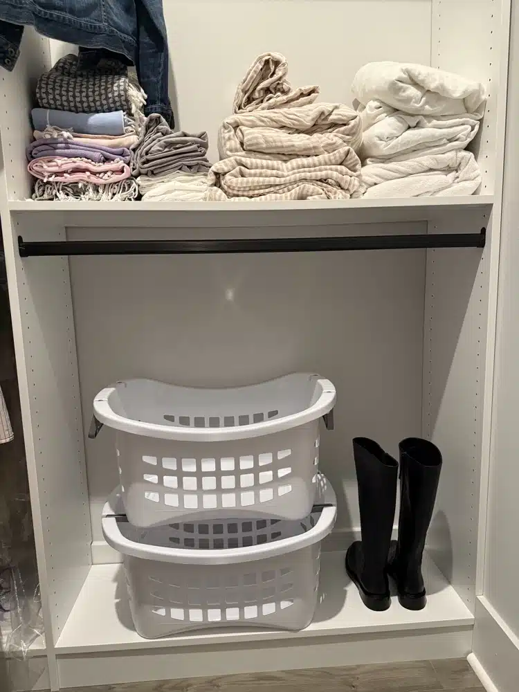 2 stacked laundry baskets on bottom walk-in closet shelf