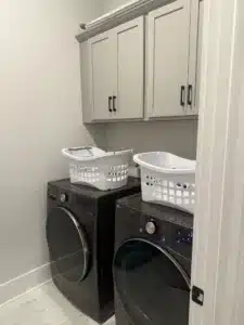 2 empty laundry baskets sitting on top of washer and dryer