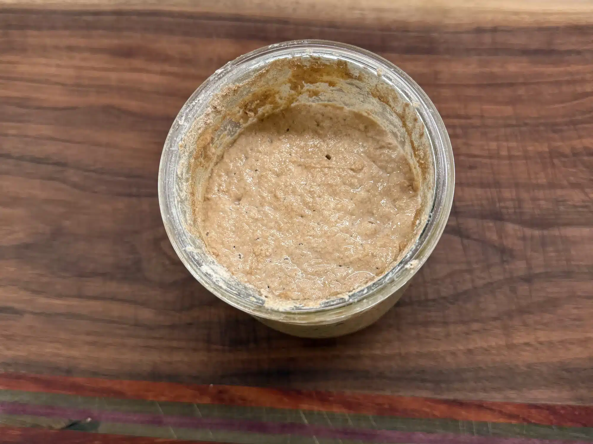 overhead shot of bubbly sourdough starter in a Weck jar