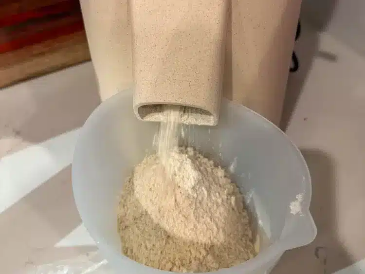 Mockmill 100 grinding einkorn berries into fresh milled einkorn flour
